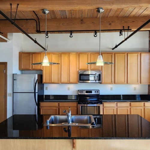 a kitchen with a brick wall