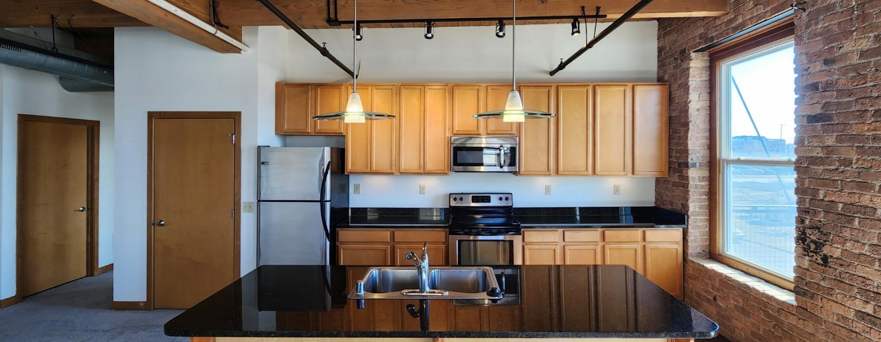 a kitchen with a brick wall