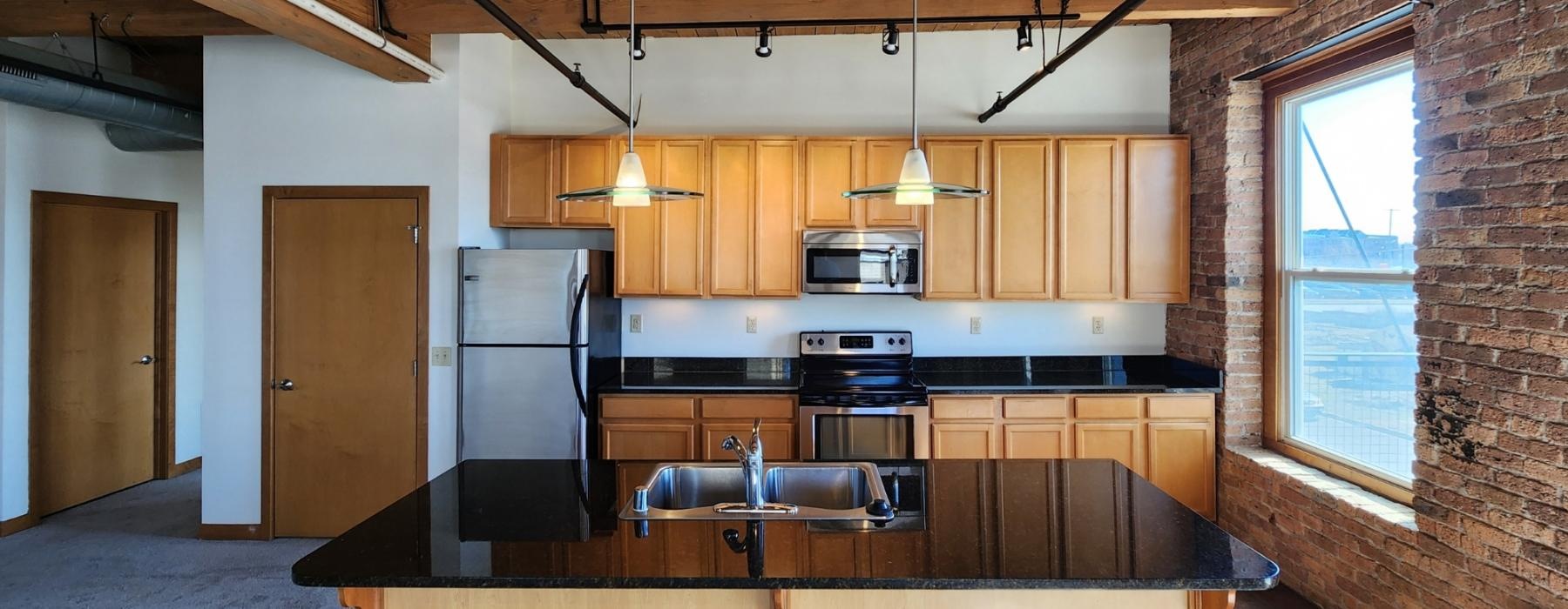a kitchen with a brick wall